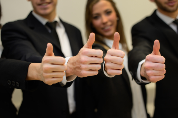 Business team holding their thumbs up N4B Team